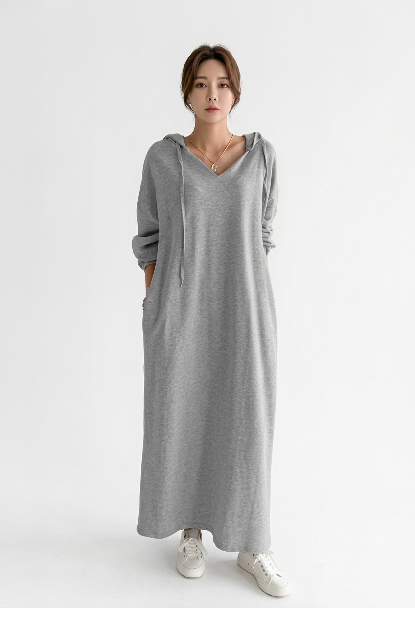 Full-body front view of grey hooded maxi sweater dress with side pockets on a white background